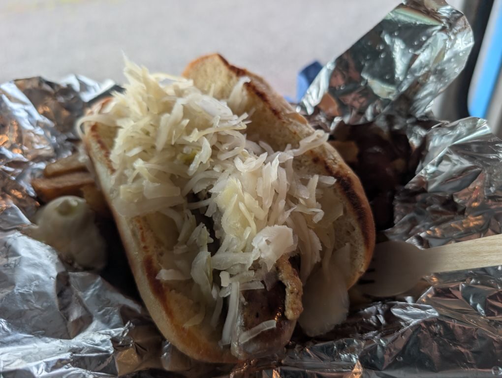 Hot dog piled with sauerkraut on a toasted roll
