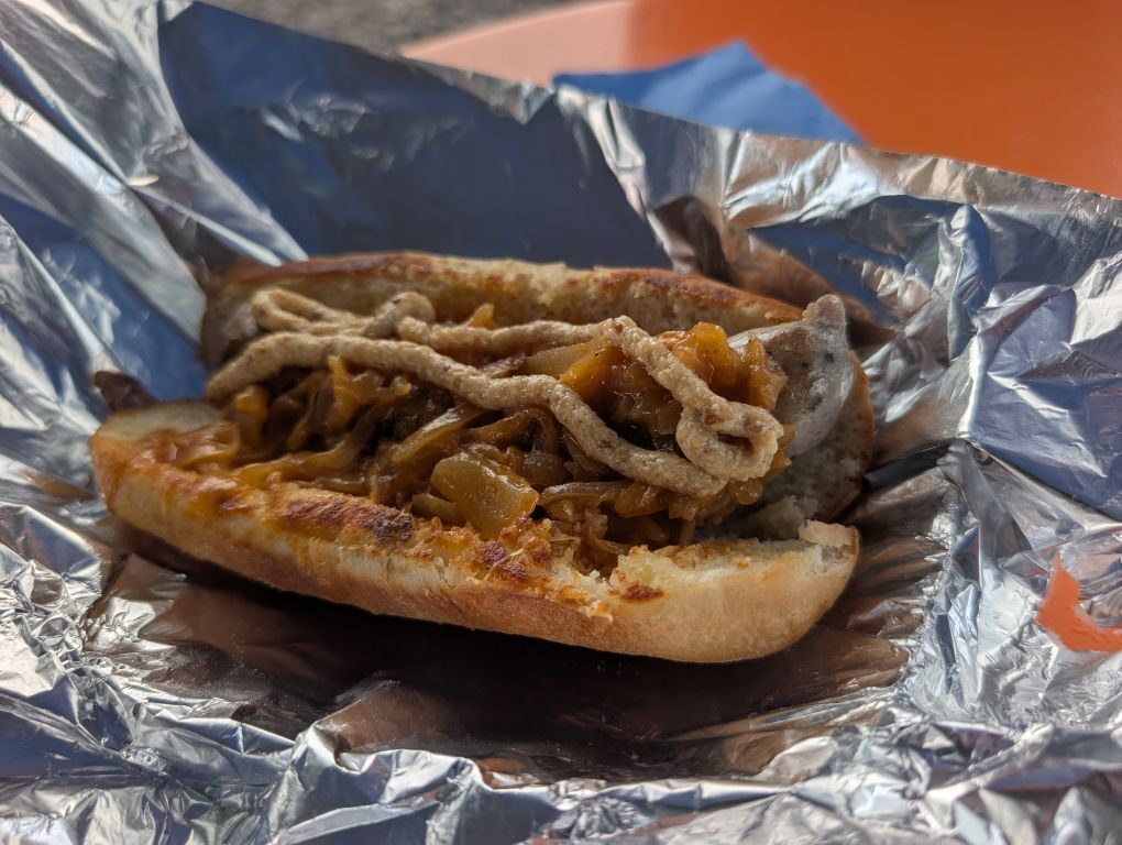 Sweet Italian sausage with peppers and onions on a toasted roll